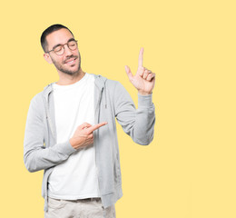 Young man making a number two gesture