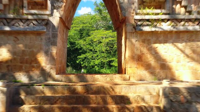 Aerial, drone shot through a building at the Labna ruins, on a sunny day, in Yucatan, Mexico