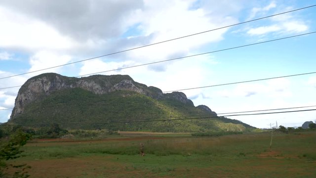 Vi&ntilde;ales Valley view from a moving car, Mogotes, mountains, farmer houses, cuban land scape