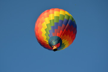 beautiful multi-colored hot air balloon against the blue sky 