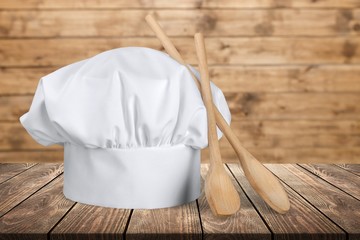White chef hat with wooden spoons