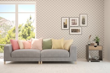 Stylish room in white color with sofa and summer landscape in window. Scandinavian interior design. 3D illustration