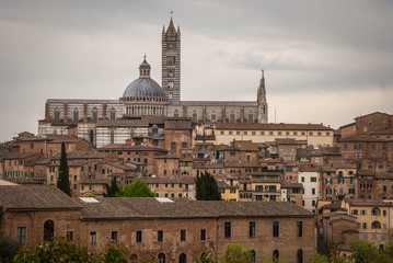 Fototapeta na wymiar Scenery of Siena, a beautiful medieval town in Tuscany, with view of the Dome & Bell Tower of Siena Cathedral (Duomo di Siena)