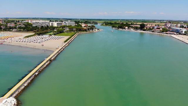 Porto Santa Margherita marina entrance from the Adriatic sea in Caorle Italy, Aerial drone flyover shot