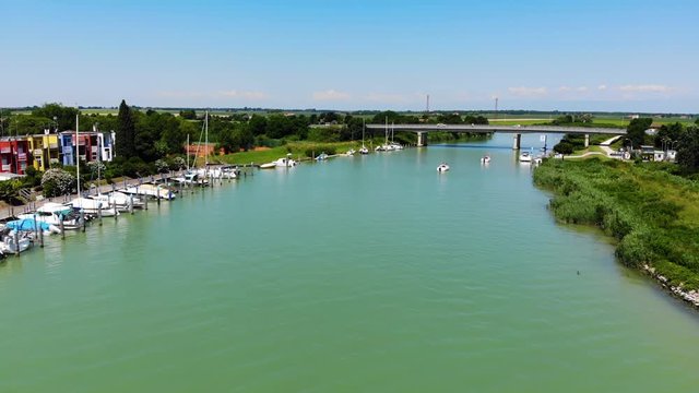 The Porto Santa Margherita marina with colorful beach condos in Caorle Italy, Aerial drone flyover shot