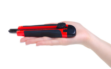 Red stationery knife office tool in hand on white background isolation