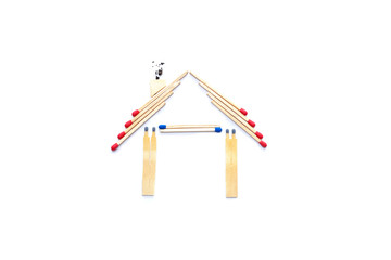 Fire insurance, Shape of House made of matches. abstract house made with matches on paper background, copy space. Concept of home protection insurance with the importance of smoke alarm systems