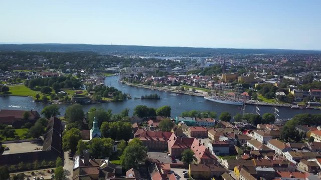 Aerial view of Tall Ship Race in Fredrikstad Norway from over fortress town with large ships in canal