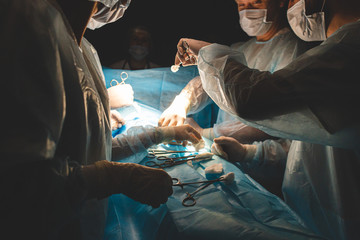 An international professional team of surgeon, assistants and anesthesiologist perform a complex...