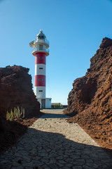 Lighthouse on Teno cape. The westernmost point of the island of Tenerife. Stone path to the...