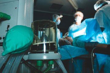 Respiratory ventilation apparatus close up and team of doctors onthe background. artificial respiration