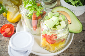 Healthy take-away lunch jar. Vegan vegetable salad in glass jars, with sliced fresh vegetables. Detox, raw eating and zero waste lunch concept