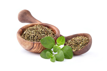 Oregano or marjoram leaves isolated  in wooden bowl on white background. Oregano fresh and dried.