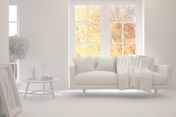 Stylish room in white color with sofa and autumn landscape in window. Scandinavian interior design. 3D illustration