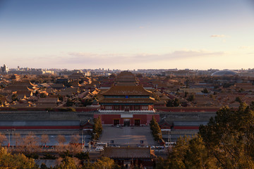 View of the Forbidden City, Beijing, China from above with beautiful sky during sunset and beautiful warm evening light. This shot was taken at Jingshan park which is centre point of Beijing.
