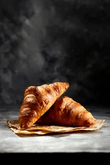 Vlies Fototapete Brot Fresh croissant on dark mood background and copy space for your product. 
