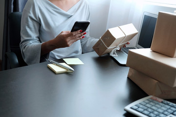 Asian woman hold and see information on mobile phone or chat as name, address or detail of...