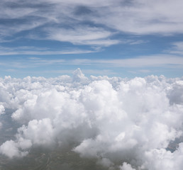 Fototapeta premium Photo from the window of an airplane. View from above on clouds and the earth. High. Sunny and cloudy day. Photo with telephone. View of the sky.