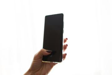Mobile phone with a black screen on a white isolated background.