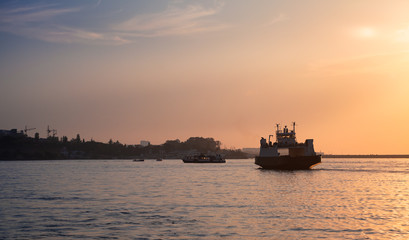 Passenger ferry goes at Sevastopol bay at sunset
