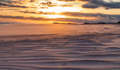 Fototapeta na wymiar Sand Ridges and Hills on Beach with Sunset Background