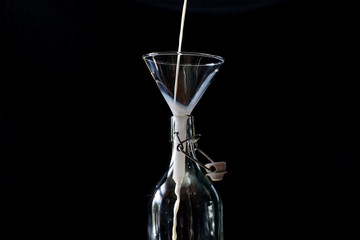 Retro closeup of neck bottle on black background.