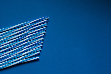 
Blue juice straws on a classic blue background