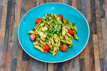 close-up of plate of pasta and chicken with lettuce