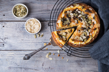 Pears and cheese pie with bowl of caramel and old spoon. Top view. Copy space flat lay
