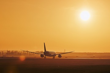 Fototapeta na wymiar Airplane on airport runway