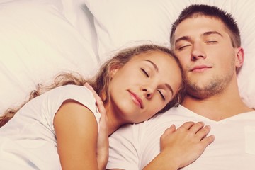 Fototapeta premium Woman and man couple sleeping together in bed