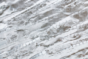 ice texture, cracked stripes and sharp edges of glass frozen water, frosty background