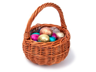 chocolate easter eggs in wooden basket isolated on the white