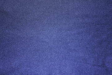 Texture background of dark blue fabric. Empty cloth surface of blue cotton material, close up view of casual shirt detail 