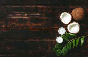 Natural cosmetics with coconut on old wooden background