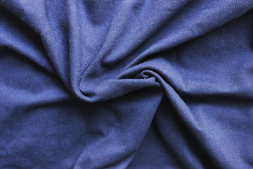 Fototapeta na wymiar Crumpled dark blue cloth texture background. Wrinkled fabric material, close up top view of wavy natural cloth material surface. Creasy blue fabric, simple textile of one color 