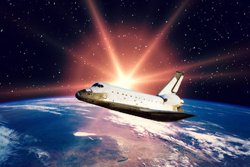 Fototapeta premium Shuttle above the planet earth. Space scene. The elements of this image furnished by NASA.