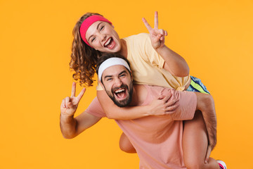 Portrait of athletic happy couple smiling while doing piggyback ride