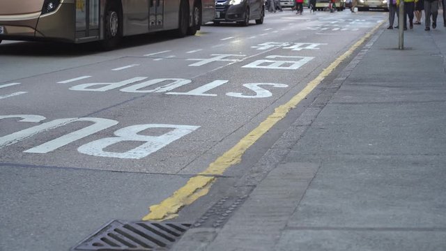 Hong Kong, China - December, 2019: People are boarding public buses in city streets during rush hour.