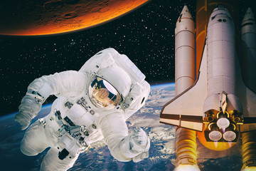 Astronauts are in deep space. Rocket and Mars on the backdrop. The elements of this image are...