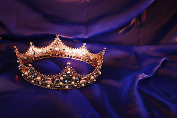 Vintage crown over dark royal purple delicate silk. fantasy medieval period © tomertu