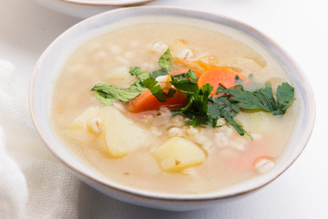 Barley soup, pearl barley in white bowl