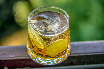 Cocktail glass with ginger and lime on natural background