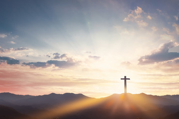 Good Friday concept: cross with sunset in the sky background