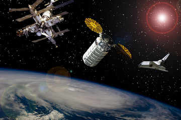 Different spaceships above the earth. Austronaut in outer space. The elements of this image...