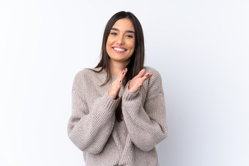 Young brunette woman over isolated white background applauding after presentation in a conference