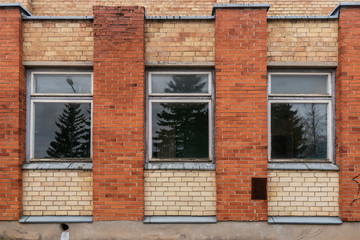 Fototapeta na wymiar Three windows of an abandoned house