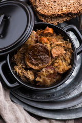 Traditional polish sauerkraut (bigos) with mushrooms and plums for christmas