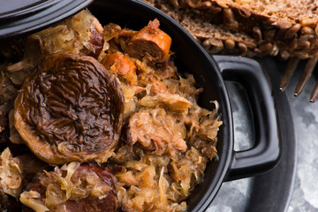 Traditional polish sauerkraut (bigos) with mushrooms and plums for christmas