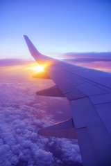 Beautiful sunset, sky on the top view, airplane flying view from inside window and cloud, sun down...